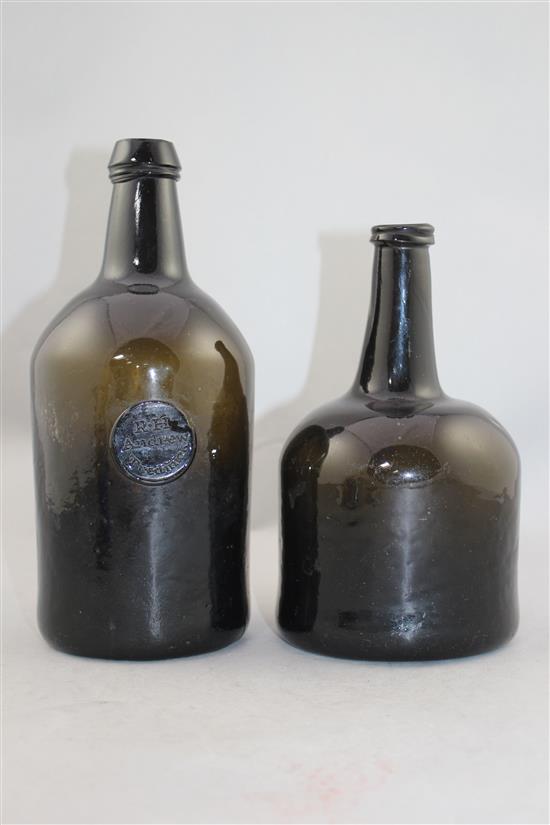 Two English dark green glass wine bottles, 18th century, 25cm.